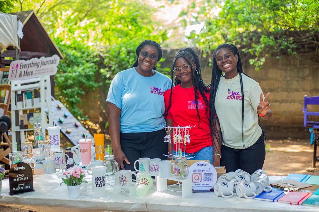 Three ladies selling customized items behind a table