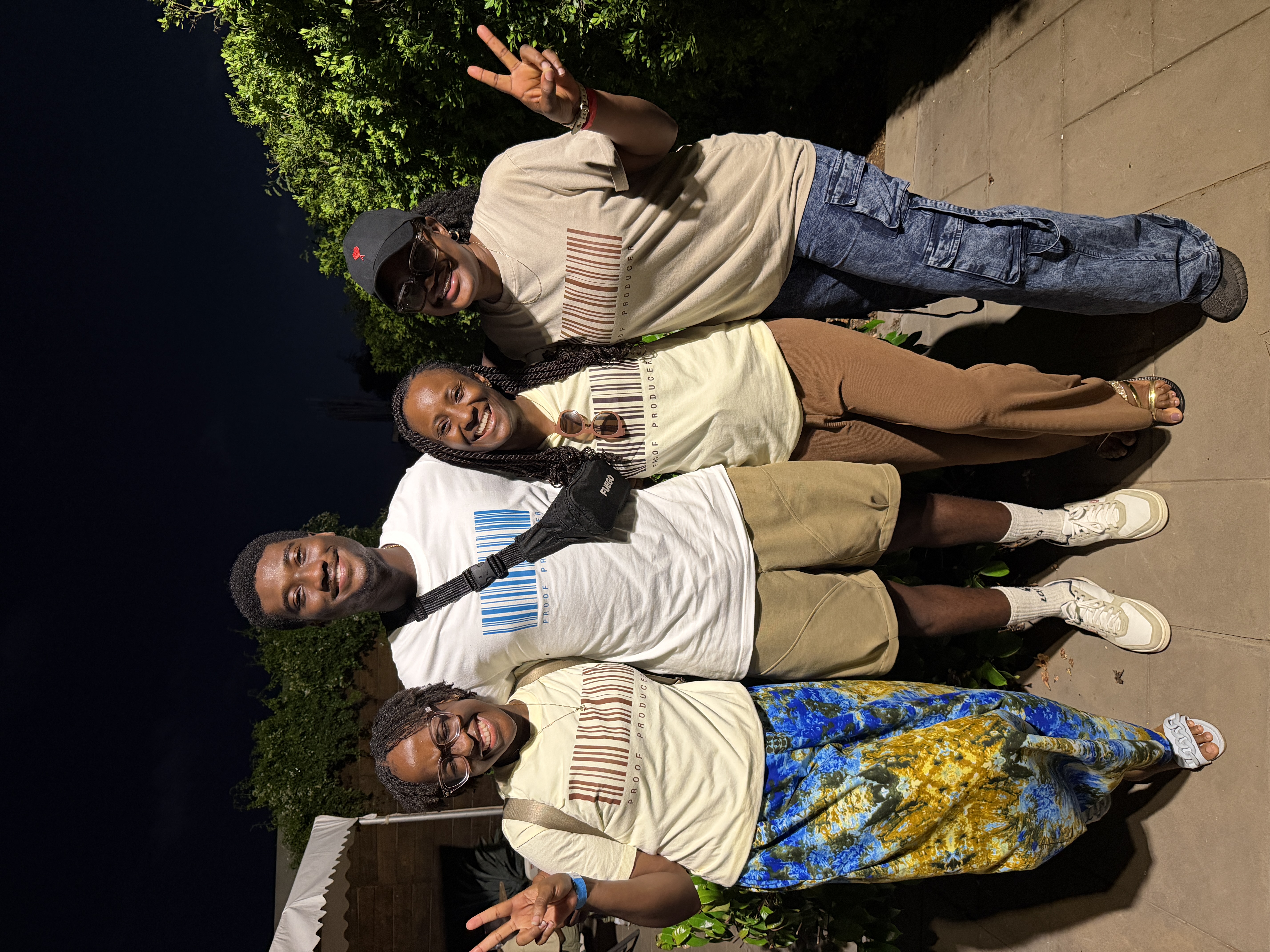 Four people wearing a proof producer shirt