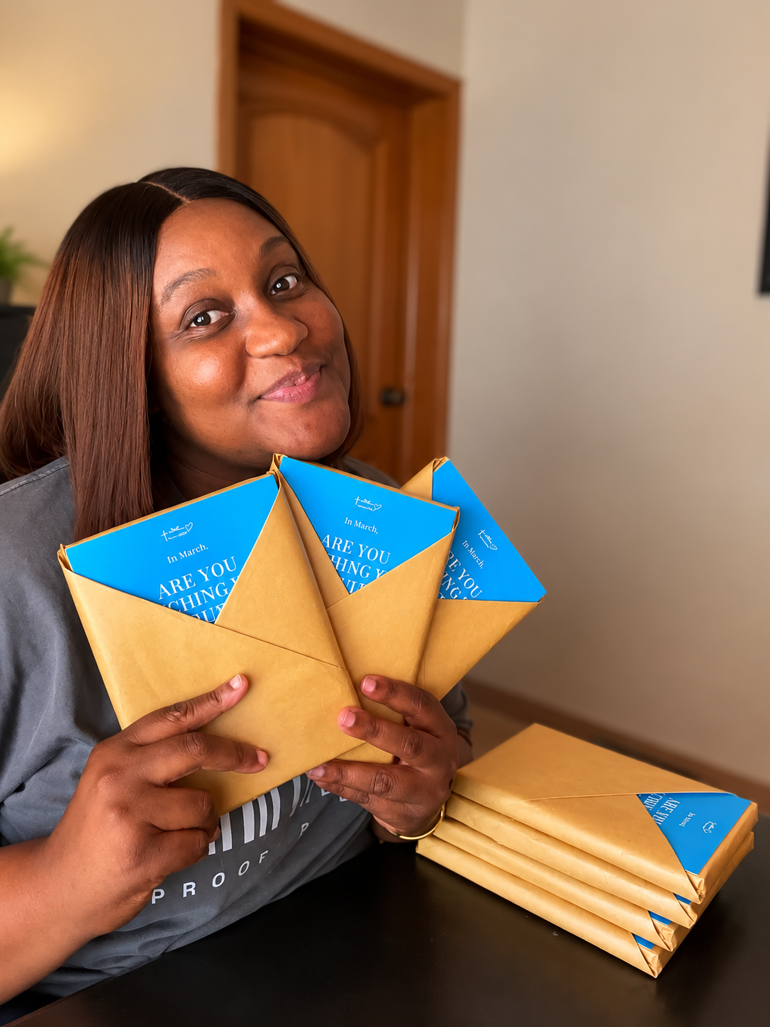 A lady holding books wrapped