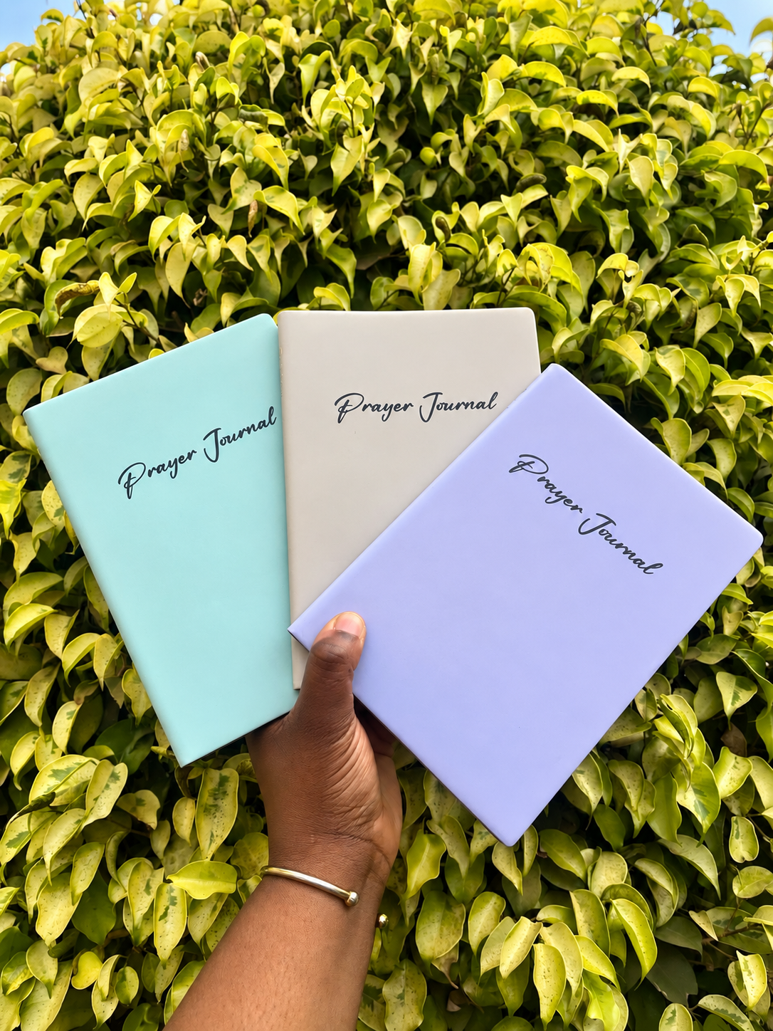 Three journals with Prayer Journal