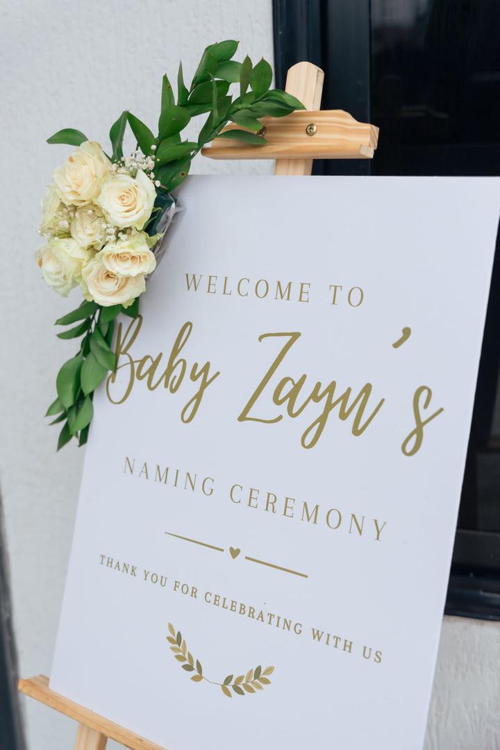 A picture signage with flowers on the side