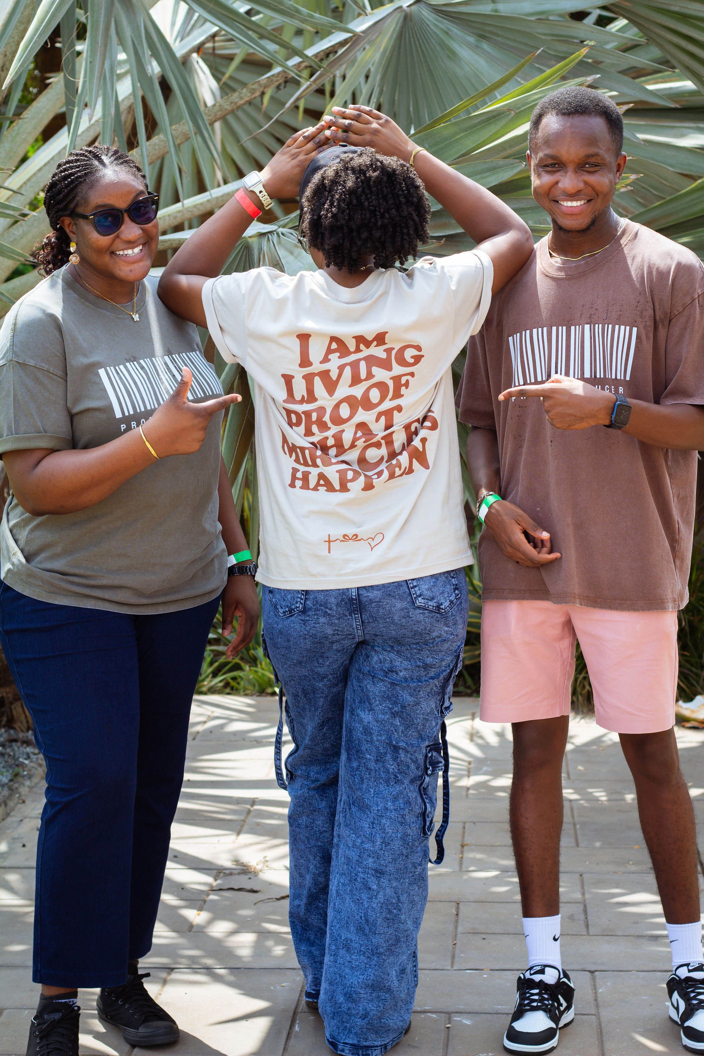 Three people wearing proof producer shirts