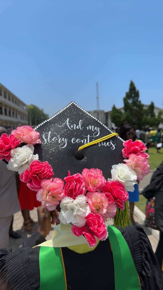 The Bloom black glitter cap topper framed with pink and white flowers