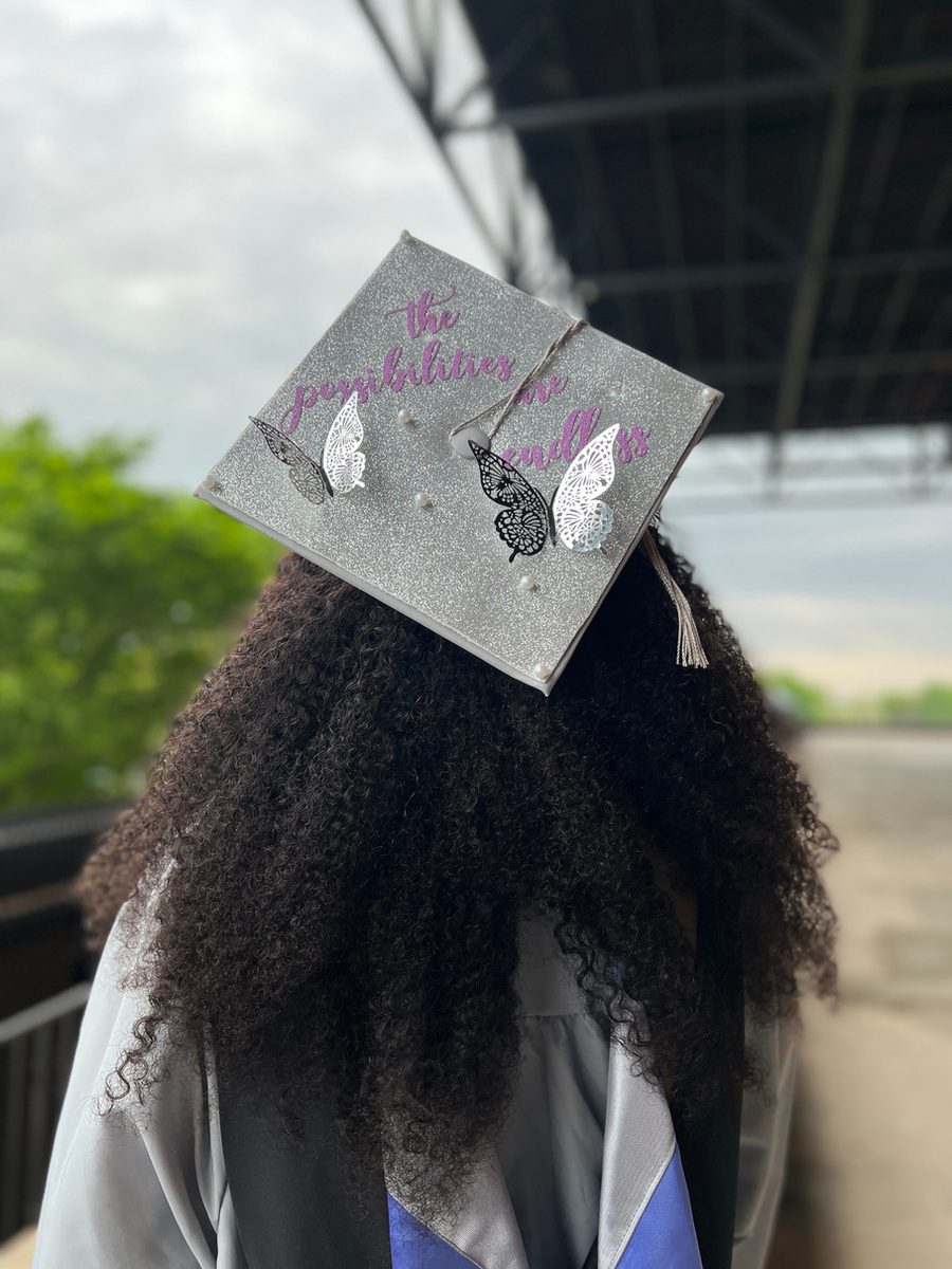 The Flutter silver glitter cap topper decorated with white butterflies